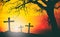 Silhouette of cross of Jesus Christ with big tree on backlight a