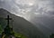 Silhouette of a cross / tomb stone on a rainy day on the Death Road in the Yungas, Bolivia