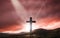 Silhouette of crucifix cross at sunset time with holy light and thunderstorm background