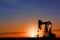 Silhouette of crude oil pump. Space for text