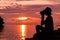 Silhouette of cute girl resting and shooting on the sea