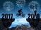Silhouette cyclist jumping into the New Year 2018