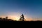 Silhouette of the cyclist riding a Moutain bike at sunset