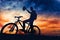 Silhouette of cyclist rising helmet after competition, winning marathon