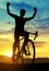Silhouette of a cyclist on a road bike.