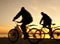 Silhouette of cyclists at sunrise