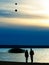 Silhouette of dating couple and two balloons in the air background