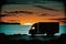 Silhouette of a Delivery Truck on a Twilight Coastal Road