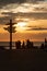 The silhouette of a direction post and a group of people during the sunset on wadden sea island Texel in the Netherlands