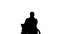 Silhouette Disabled old man in wheelchair typing on laptop.