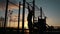 Silhouette of disabled young man pulled up on the crossbars at the sunset outdoors