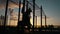 Silhouette of disabled young man pulled up on the crossbars at the sunset outdoors