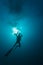 Silhouette of diver ascending to surface after scuba dive