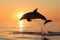 silhouette of dolphin leaping at sunrise