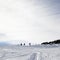 Silhouette of downhill snowboarder on snowy off-piste slope in w