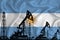 Silhouette of drilling rigs and oil derricks on the background of the flag of Argentina. Oil and gas industry. The concept of oil