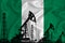 Silhouette of drilling rigs and oil derricks on the background of the flag of Nigeria. Oil and gas industry. The concept of oil