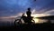 The silhouette of the driver of the extreme transport who stands near his motorcycle, the man on the background of the