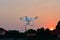 Silhouette drone fly for take aerial photo at sunset evening ora