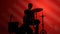 Silhouette drummer playing drum on a red background. Studio shot footage