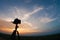 Silhouette DSLR Camera on tripod shooting in the sky dramatic an