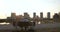 Silhouette of an elderly couple sitting on a bench against the backdrop of a cityscape