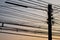 Silhouette Electric pole with wire and lamp on orange sky in the evening