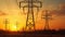 Silhouette electricity pylons at sunset