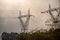 Silhouette of electricity transmission towers at dawn