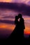 Silhouette of Embracing Asian Bride and Groom at Sunset