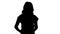 Silhouette Emotional happy and positive beautiful young woman talking and walking with hands in pockets.