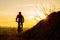 Silhouette of Enduro Cyclist Riding the Mountain Bike on the Rocky Trail at Sunset. Active Lifestyle Concept. Space for Text.