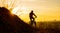 Silhouette of Enduro Cyclist Riding the Mountain Bike on the Rocky Trail at Sunset. Active Lifestyle Concept. Space for Text.