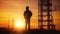 Silhouette of Engineer checking project at building site background, construction site at sunset in evening time