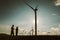 Silhouette of engineers at wind turbine electricity