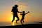 Silhouette of exciting woman with children having