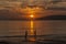 Silhouette of family against glorious sunset on the sea, Ao Nang, Province of Krabi, Thailand