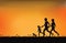 Silhouette of family exercising and jogging together at the park