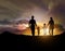 Silhouette of family facing the sunset