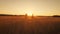 Silhouette family farmers working in a wheat field at sunset. Young parents with their daughter in a wheat field. The