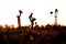 Silhouette of family in field with windmill