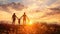 Silhouette of a family holding hands at sunset in a field.