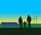Silhouette of a family looking at a landscape of solar panels and windmills with a setting sun