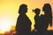 Silhouette family with mother, daughter and grandmother outdoor. Fall season