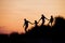 Silhouette of Family Running Through the Sand Dunes