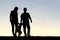 Silhouette of Family of Three People Walking at Sunset