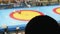 Silhouette of fan who watches duelling on sambo. The action is unfocused. Fan is unrecognizable.