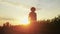 silhouette farmer. a male farmer walk along a road among sun a field of sunflowers. farm agriculture business concept