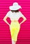 Silhouette fashion pretty woman in summer straw hat skirt over colorful pink