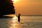 Silhouette Father and daughter enjoy swimming and snorkeling near the beach with sunset